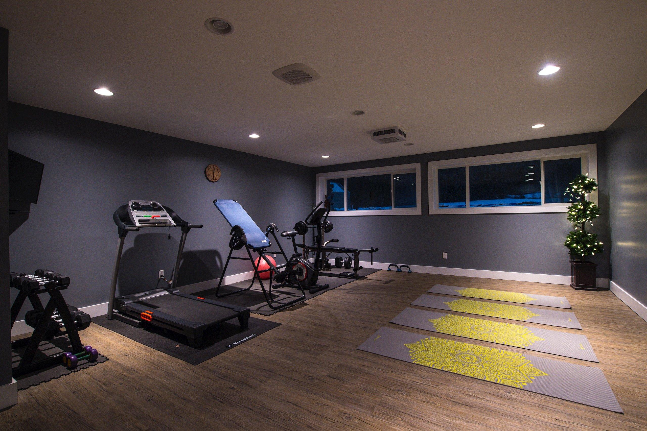 A large room full of workout gear and yoga mats