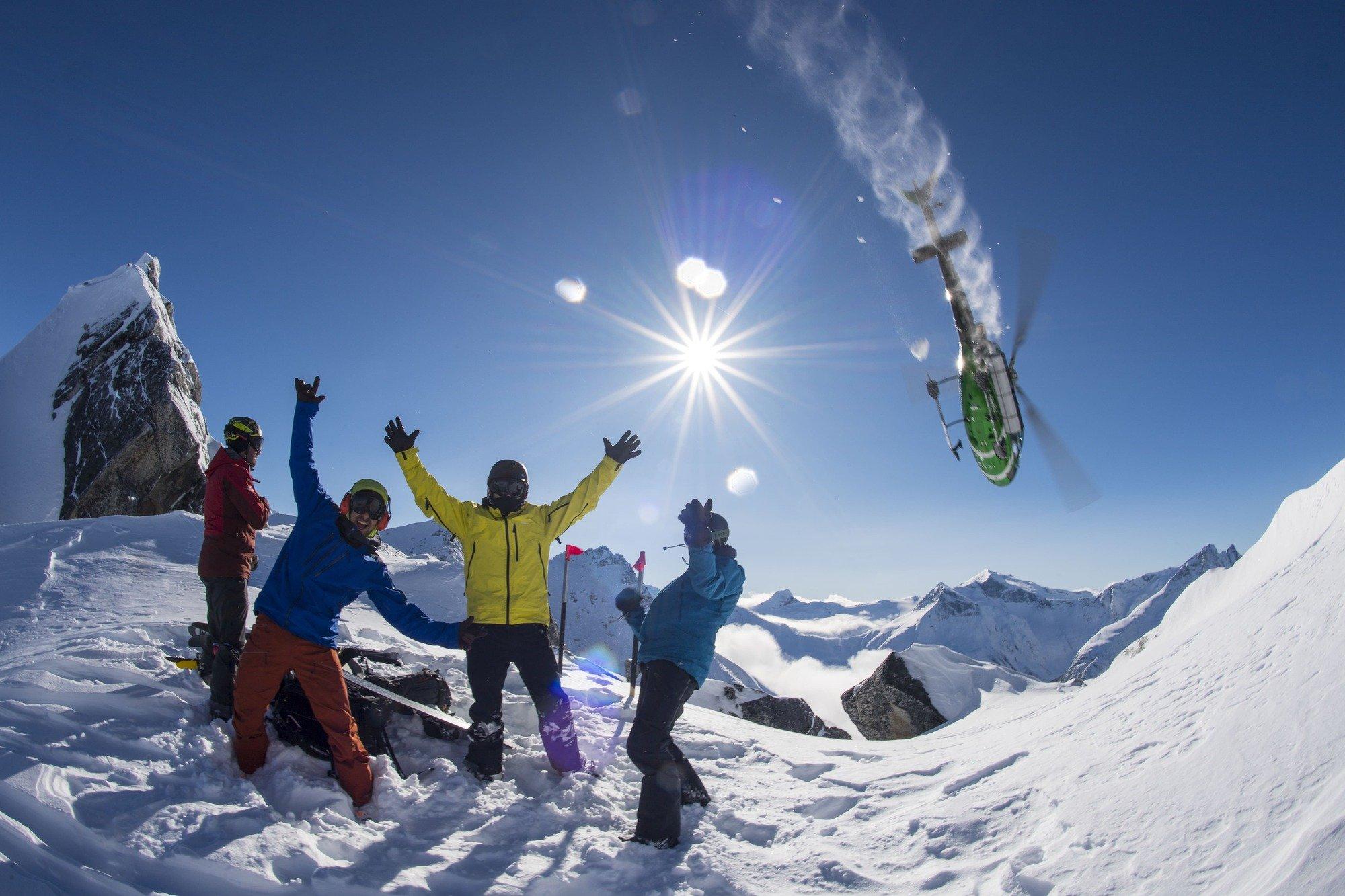 Group raising their hands as a helicopter flies over them